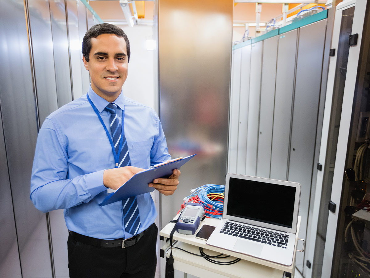 a person holding a clipboard in a server room