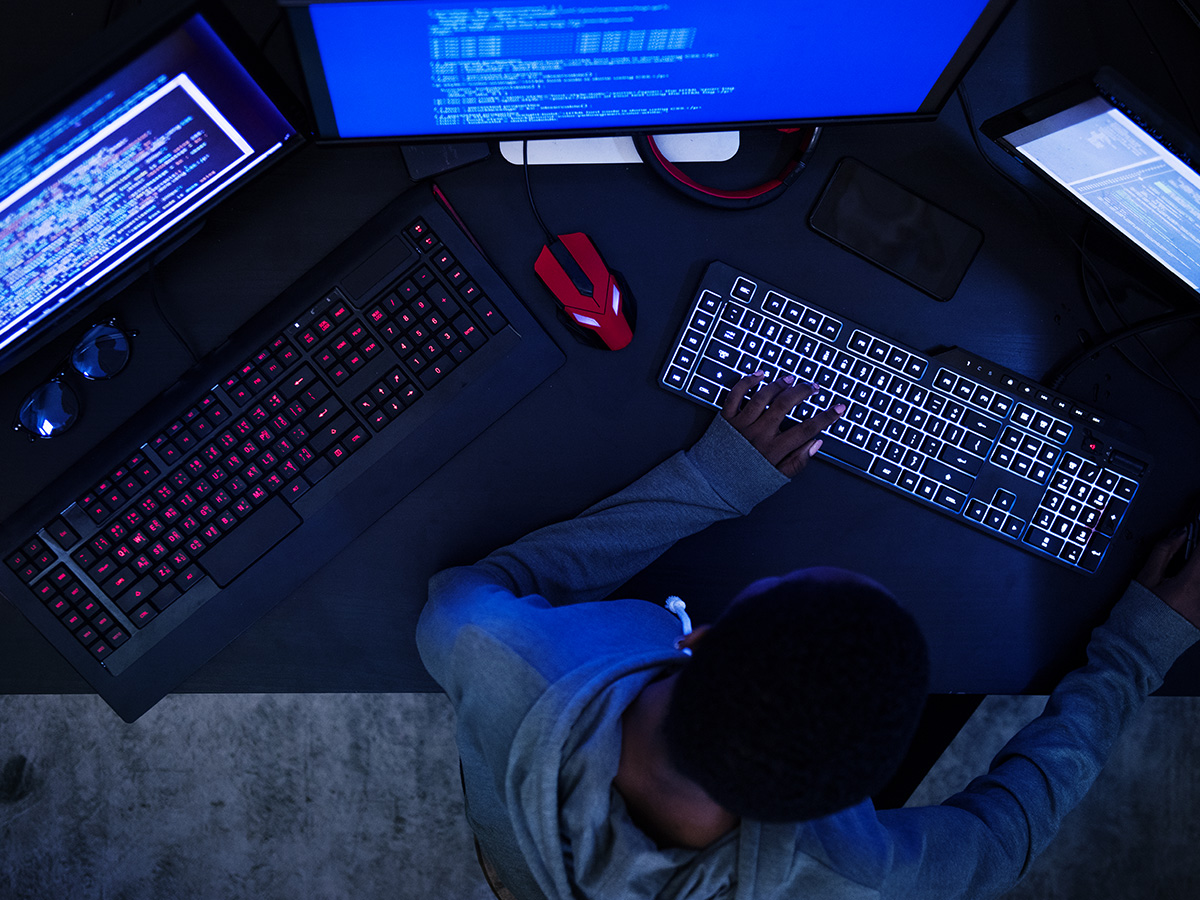 hacker on three desktops
